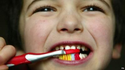 Young child brushing his teeth