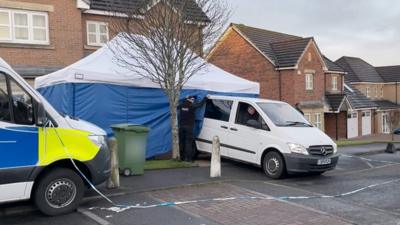 Van reverses into tent