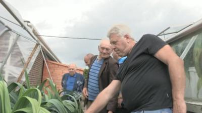 Prize leek growers in Ashington