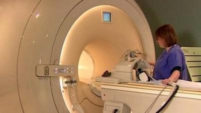 Nurse operating MRI scanner