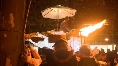 Mechanical structure parades through crowds