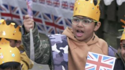 School child waving union jack flag