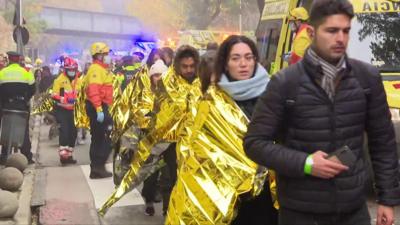 Passengers wrapped in foil blankets