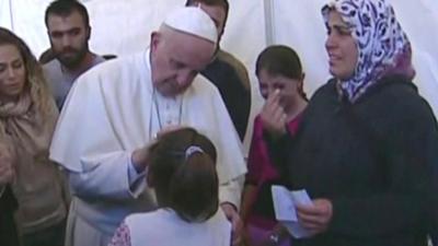 Pope Francis blesses a girl in the Lesbos migrant camp