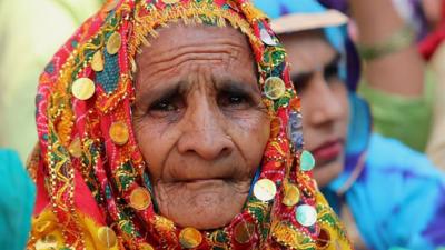 An Indian elderly woman farmer from Haryana listens to speeches at the protest sites of Tikri border (Delhi-Haryana Border) during ongoing protest against the Centre's new agricultural laws.