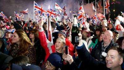 People waving Union Jack flags