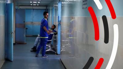 A medical worker in a corridor at Al-Shifa hospital