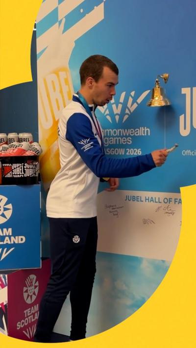 Ben Sandilands breaks bell after winning gold at the Commonwealth Games