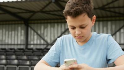 Young boy on his smartphone