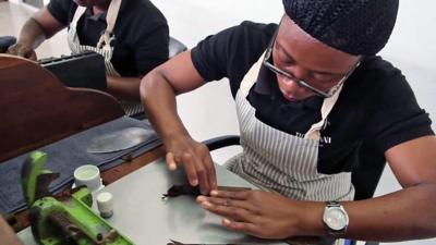 women rolling cigars