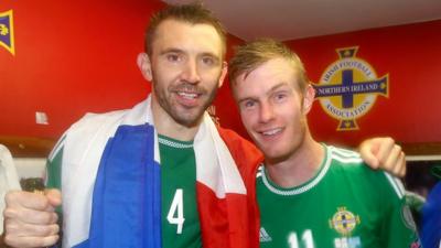 Gareth McAuley celebrates with Chris Brunt