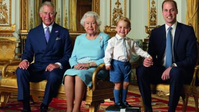 Prince George stands on foam blocks during a Royal Mail photo shoot for a stamp sheet to mark the Queen's 90th birthday. The sheet also features - Prince Charles, the Queen and Prince William