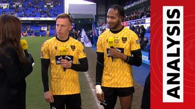 Maidstone United's Sam Corne and Lamar Reynolds talking to Alex Scott