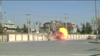 Afghan security forces use explosives on a compound wall