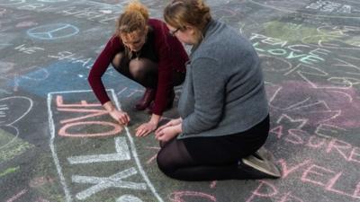 Women writing in chalk