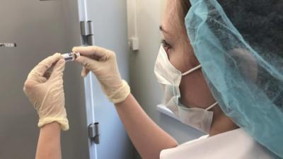 Woman holding a vial