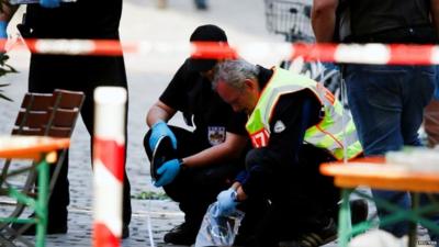 Police secure the area after an explosion in Ansbach, Germany