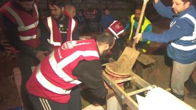 Volunteers helping with sandbags