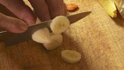 Man cutting banana