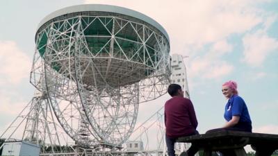 Boy-and-woman-sit-near-jodrell-bank.