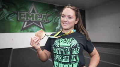 Amy tinkelr holding her Olympic bronze