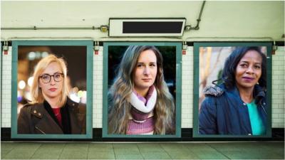 Women on posters in a subway