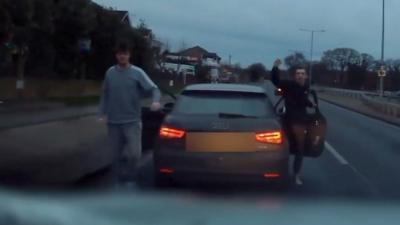 Men gesturing at another vehicle on A127