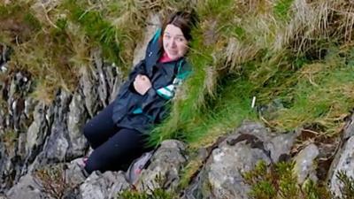 Woman stuck on side of mountain