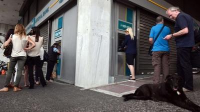 People queue at Greek bank cash machine in Athens