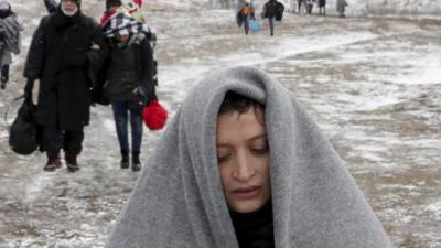 A refugee at the Turkish / Syrian border