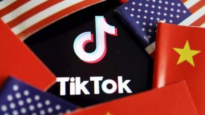 Chinese and U.S. flags are seen near a TikTok logo