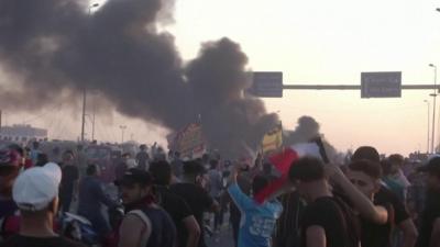 Smoke billows during a protest rally in Baghdad