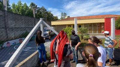 Several people wait outside a nursery