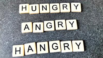 'Hungry', 'Angry' and 'Hangry' spelt out in Scrabble tiles