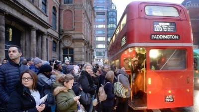 Commuters trying to board London bus