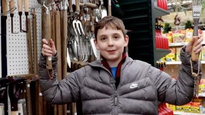 Dominic holding gardening tools