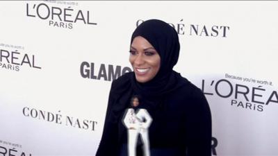 Ibtihaj Muhammad with the Barbie doll that is modeled on her