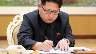 Kim Jong-Un signing a document relating to the hydrogen bomb test