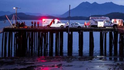 Rescue personnel mounting a search for victims of a capsized whale-watching boat park on a wharf in Tofino, British Columbia