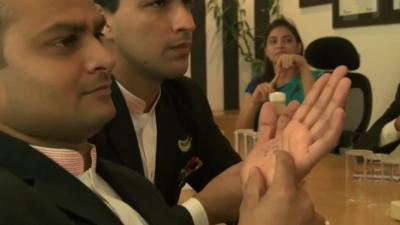 Indian businesspeople learning sign language