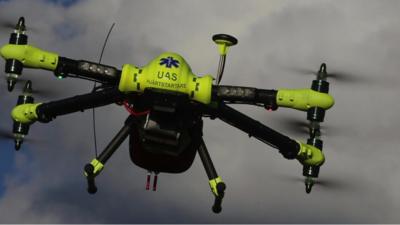 A drone carrying a defibrillator