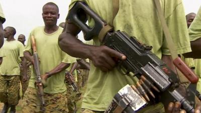 Soldiers march with guns