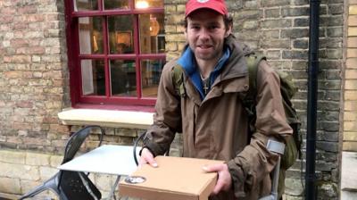 Man holding a pizza box