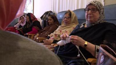 Seated women talking