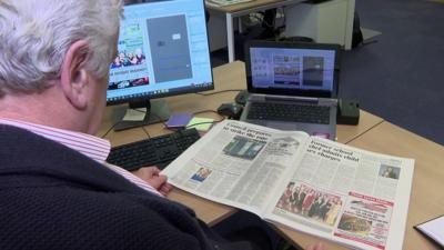 Man reading newspaper