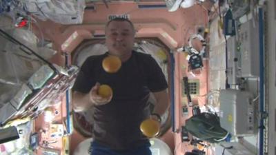 Spaceman juggles balls