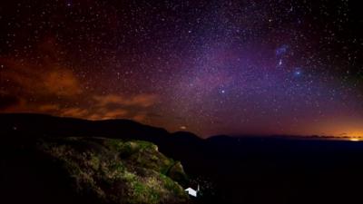 Sky at night with purple hue and stars