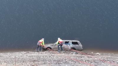 Volunteers reach the old car