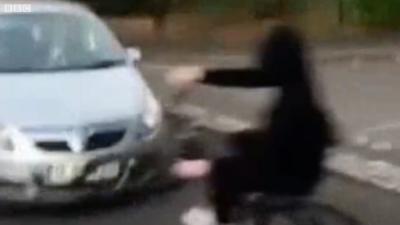 Boy cycling into car