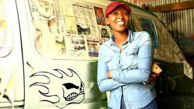 Tsarah Arts next to one of her matatus